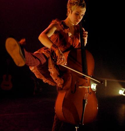 Laura Durrant dancing while playing the cello. Photo by Brian Hartley